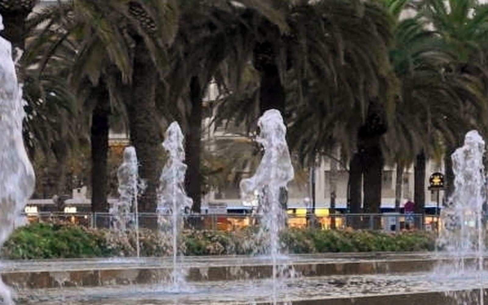 Het strand en de boulevard van Salou bij avond met verlichte palmbomen